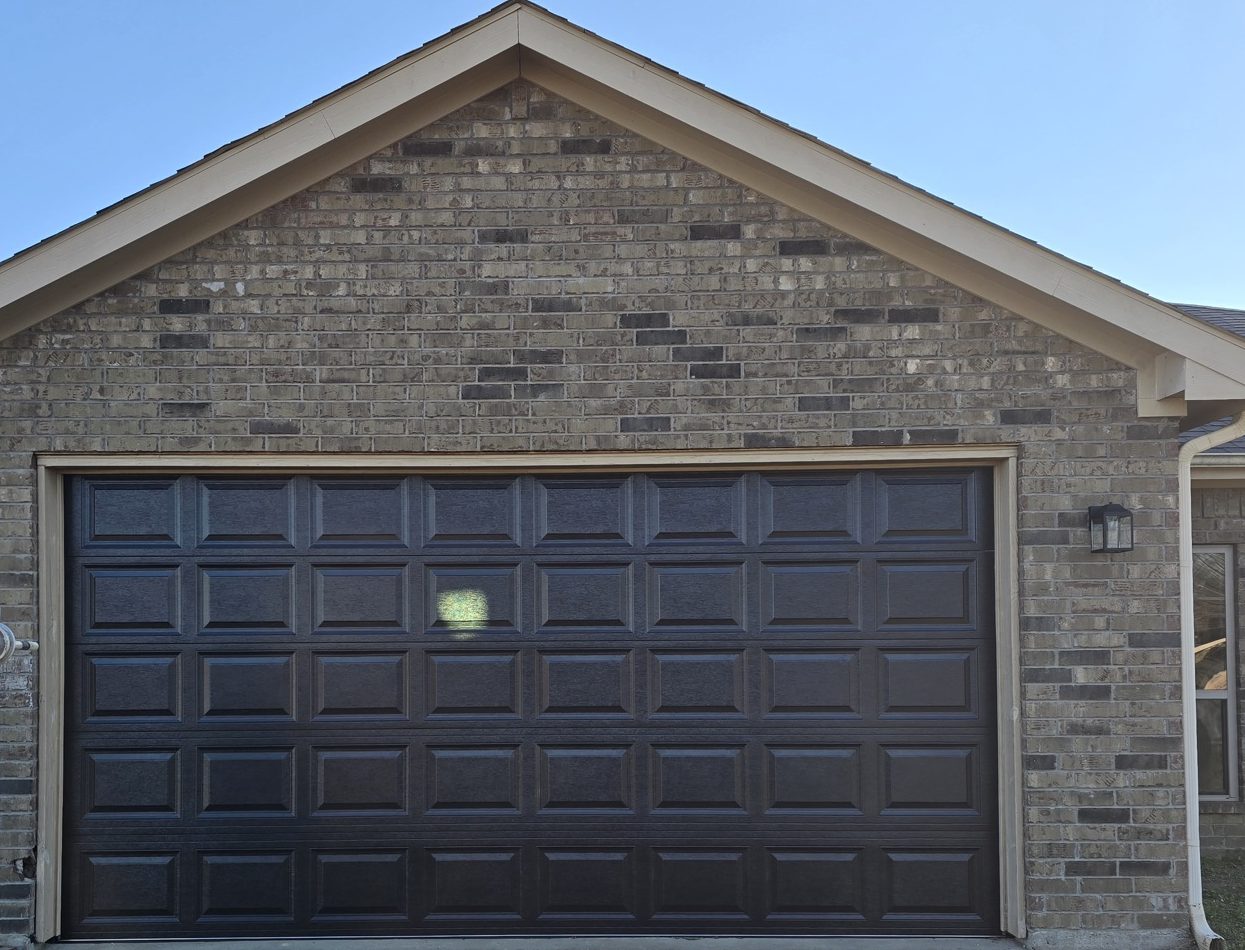 A single dark raised-panel garage door