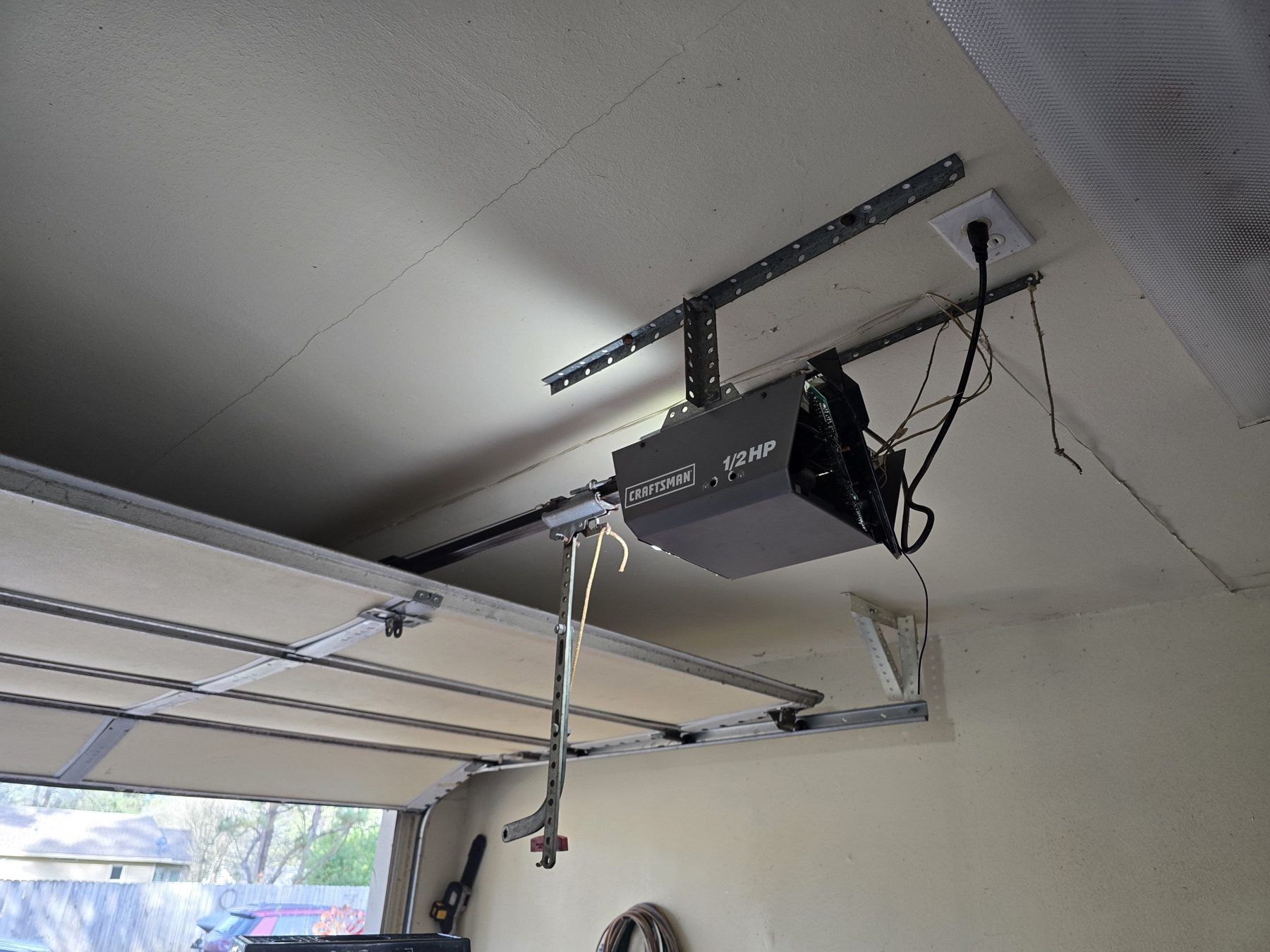A garage door opener installed on the garage ceiling